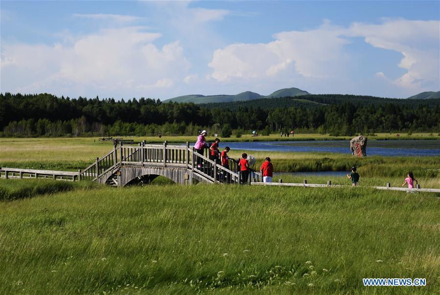 Photo taken on July 11, 2017 shows tourists visiting the Qixing Lake Scenic Area of the Saihanba State Forest Park in Chengde City, north China\'s Hebei Province. Saihanba is a vast forest covering nearly 75,000 hectares. It was a piece of barren land 55 years ago, but decades of hard afforestation efforts turned it into an important ecological shield for Beijing and Tianjin. China has seen reduced desertification and increased forest coverage since 1978, thanks to the Three-North Afforestation Program (TNAP), said a report released on Dec. 24, 2018. Constructed in the northeast, north and northwest China, TNAP is a national program fighting against soil erosion and wind-sand damage by planting sand-fixing forests. The area of sand-fixing forests has increased by 154 percent in the past 40 years, contributing to the reduction of desertification by around 15 percent, according to a report jointly released by the National Forestry and Grassland Administration (NFGA) and the Chinese Academy of Sciences. Over the past 40 years, TNAP increased the forest area by 30.14 million hectares and raised the forest coverage rate from 5.05 percent to 13.57 percent in the regions it covers, said Liu Dongsheng, deputy head of the NFGA. (Xinhua/Wang Xiao)