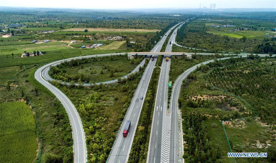 Vehicles run on the Yulin-Jingbian Expressway which runs through the Maowusu Desert, northwest China\'s Shaanxi Province, Aug. 1, 2018. The expressway is the first of the kind built in a desert in China. China has seen reduced desertification and increased forest coverage since 1978, thanks to the Three-North Afforestation Program (TNAP), said a report released on Dec. 24, 2018. Constructed in the northeast, north and northwest China, TNAP is a national program fighting against soil erosion and wind-sand damage by planting sand-fixing forests. The area of sand-fixing forests has increased by 154 percent in the past 40 years, contributing to the reduction of desertification by around 15 percent, according to a report jointly released by the National Forestry and Grassland Administration (NFGA) and the Chinese Academy of Sciences. Over the past 40 years, TNAP increased the forest area by 30.14 million hectares and raised the forest coverage rate from 5.05 percent to 13.57 percent in the regions it covers, said Liu Dongsheng, deputy head of the NFGA. (Xinhua/Tao Ming)