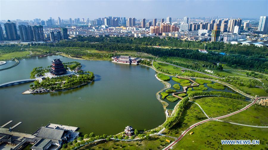 Aerial photo taken on Aug. 2, 2018 shows a view of the Yuxihe Park in the Yuyang District of Yulin City on the verge of the Maowusu Desert in northwest China\'s Shaanxi Province. China has seen reduced desertification and increased forest coverage since 1978, thanks to the Three-North Afforestation Program (TNAP), said a report released on Dec. 24, 2018. Constructed in the northeast, north and northwest China, TNAP is a national program fighting against soil erosion and wind-sand damage by planting sand-fixing forests. The area of sand-fixing forests has increased by 154 percent in the past 40 years, contributing to the reduction of desertification by around 15 percent, according to a report jointly released by the National Forestry and Grassland Administration (NFGA) and the Chinese Academy of Sciences. Over the past 40 years, TNAP increased the forest area by 30.14 million hectares and raised the forest coverage rate from 5.05 percent to 13.57 percent in the regions it covers, said Liu Dongsheng, deputy head of the NFGA. (Xinhua/Tao Ming)