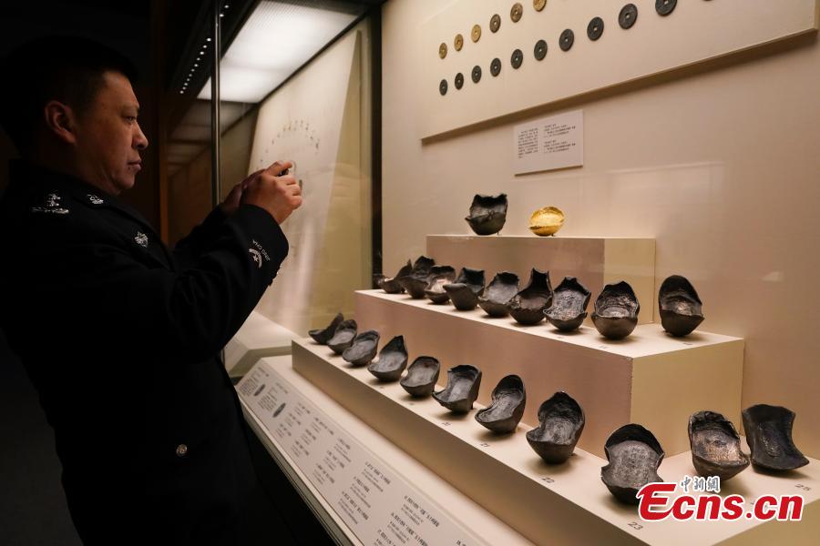 Cultural relics, including bronze wares and silver ingots, retrieved by police are on display at an exhibition at the National Museum of China in Beijing, Dec. 26, 2018. The exhibition displays 750 precious artifacts retrieved during police efforts in recent years fighting crime involving stolen cultural treasures, which hail from Neolithic times through to the Qing Dynasty. (Photo: China News Service/Du Yang)