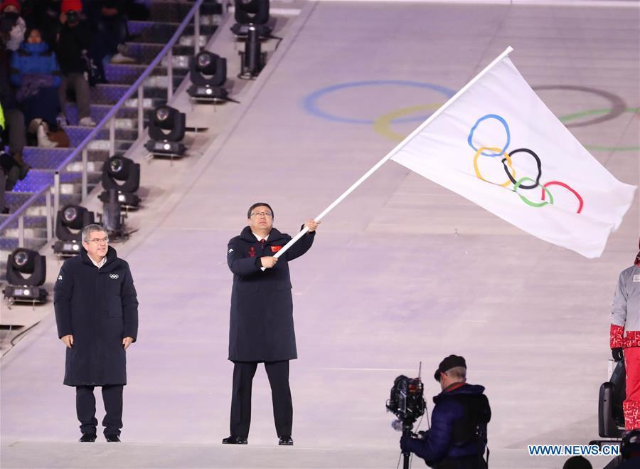 File photo taken on Feb. 25, 2018 shows Chen Jining (2nd L), mayor of Beijing, China, waves Olympic flag during the closing ceremony for the 2018 PyeongChang Winter Olympic Games at PyeongChang Olympic Stadium, PyeongChang, South Korea. The Olympic Winter Games have now officially entered \