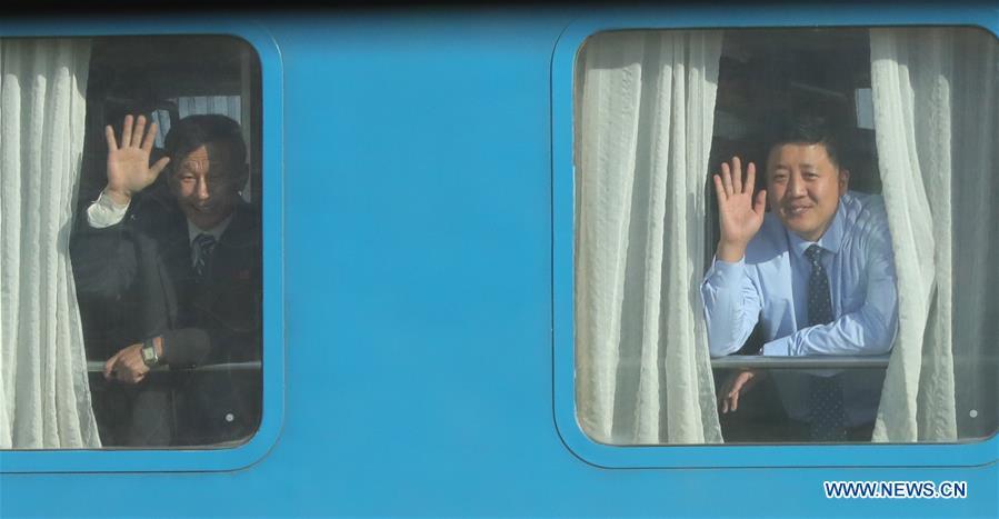 Passengers of the Democratic People\'s Republic of Korea (DPRK) wave to South korean reporters in the DPRK\'s border town of Kaesong on Dec. 26, 2018. South Korea and DPRK on Wednesday held a groundbreaking ceremony to modernize and eventually connect railways and roads across the inter-Korean border. (Xinhua)