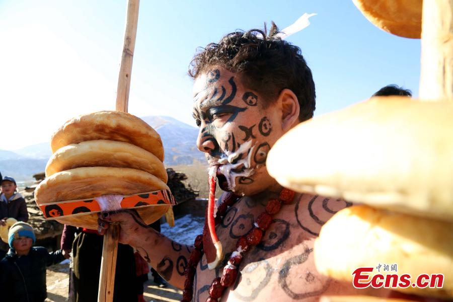 People of the Tu ethnic group perform the Wutu dance during a ceremony at Nianduhu village in Tongren County, Northwest China\'s Qinghai Province, December 26, 2018. The annual ceremony is held, between Nov. 5 to 20 in the lunar calendar, to dispel disease and exorcise evils. In ancient Chinese dialects, \
