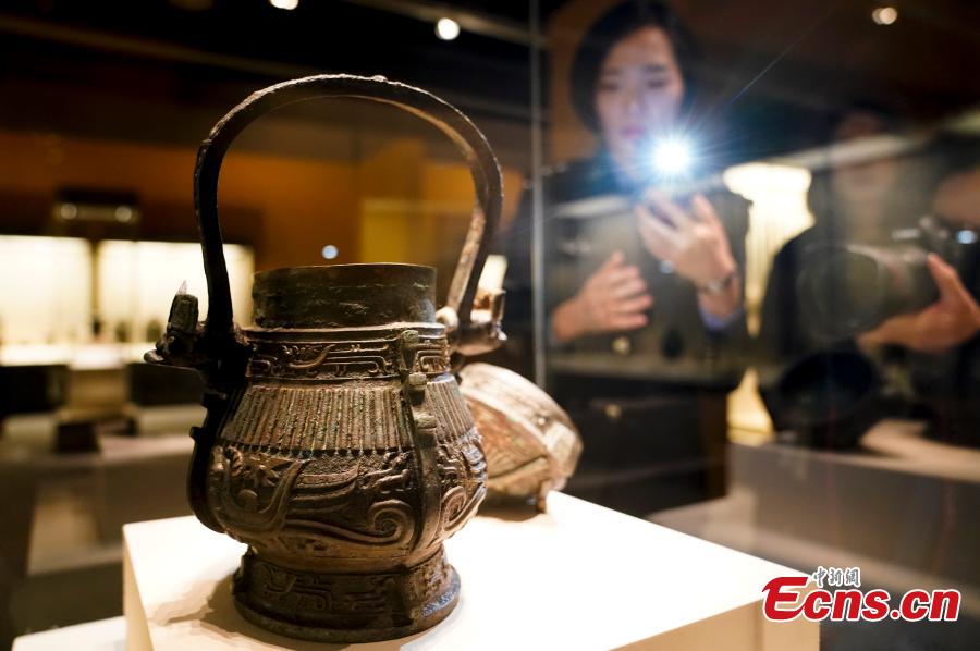 Cultural relics, including bronze wares and silver ingots, retrieved by police are on display at an exhibition at the National Museum of China in Beijing, Dec. 26, 2018. The exhibition displays 750 precious artifacts retrieved during police efforts in recent years fighting crime involving stolen cultural treasures, which hail from Neolithic times through to the Qing Dynasty. (Photo: China News Service/Du Yang)