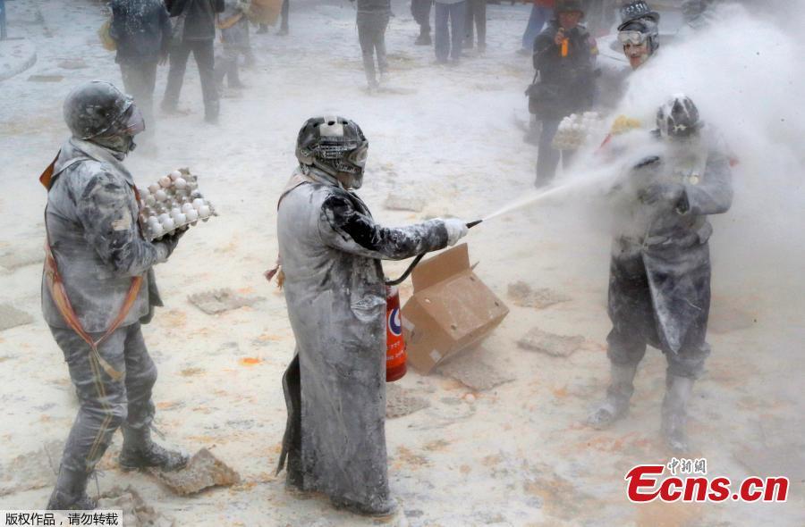 Revelers battle with flour and eggs during the traditional \