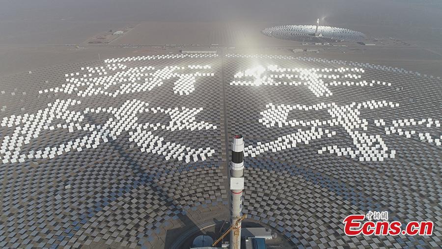 Mirrors are arranged to form New Year greetings in Chinese at a 100-megawatt molten-salt solar thermal power plant in Dunhuang City, Northwest China’s Gansu Province, Jan. 1, 2019. The plant is powered by 12,000 mirrors that concentrate sunlight onto a receiver at the top of a solar tower, 260 meters high. The heat collected is used to create steam that turns a turbine and generator, as at a traditional thermal power plant. The molten salt can also be stored and used to generate power on demand, even at night. (Photo: China News Service/Zhou Binquan)