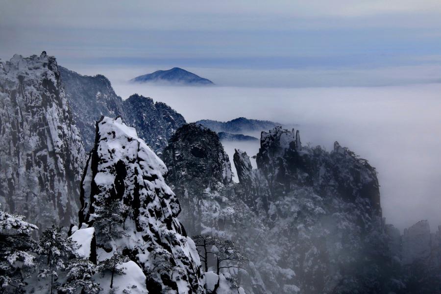 Huangshan Mountain scenic area in Anhui province is shrouded in a mantle of white after a snowfall, Jan. 1, 2019. Clouds and misty air envelop the towering mountain peaks, creating a breathtakingly beautiful scene. (Photo/Asianewsphoto)