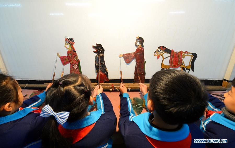 Students perform in a shadow puppetry show at Yangguang Experimental Primary School in Handan City, north China\'s Hebei Province, Dec. 11, 2018. China\'s primary and middle schools have been urged to improve education for all-around student development, according to a directive issued by authorities. Jointly issued by the Ministry of Education and other eight agencies, the circular asked schools to offer courses that are in accord with the national syllabus in terms of their quantity and quality. The enhancement of courses\' difficulty levels and speed at random and in disregard of the curriculum is prohibited, according to the circular. Primary and junior middle schools are not allowed to set up any \