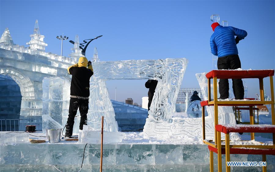 Contestants carve an ice sculpture during an international ice sculpture competition in Harbin, capital of northeast China\'s Heilongjiang Province, Jan. 2, 2019. A total of 16 teams from 12 countries and regions took part in the competition. (Xinhua/Wang Jianwei)