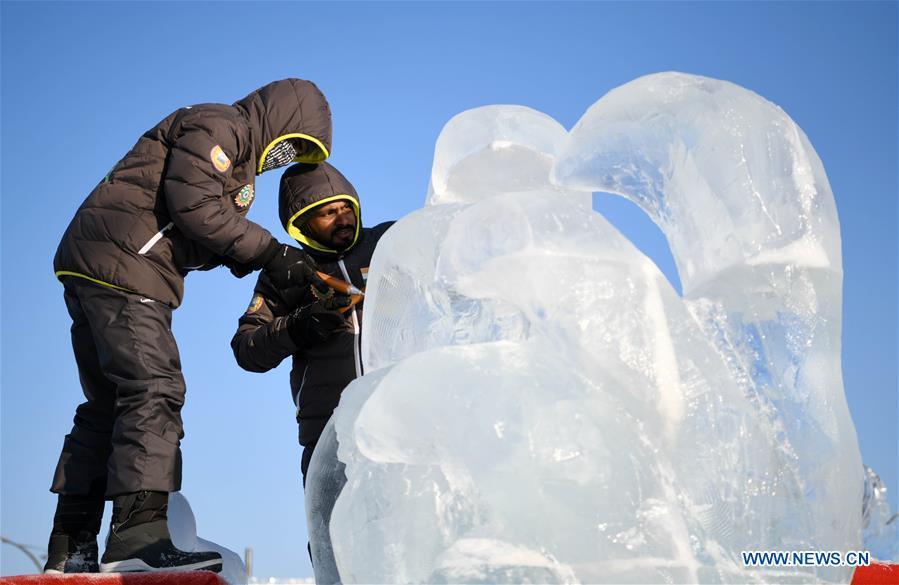 Contestants carve an ice sculpture during an international ice sculpture competition in Harbin, capital of northeast China\'s Heilongjiang Province, Jan. 2, 2019. A total of 16 teams from 12 countries and regions took part in the competition. (Xinhua/Wang Jianwei)