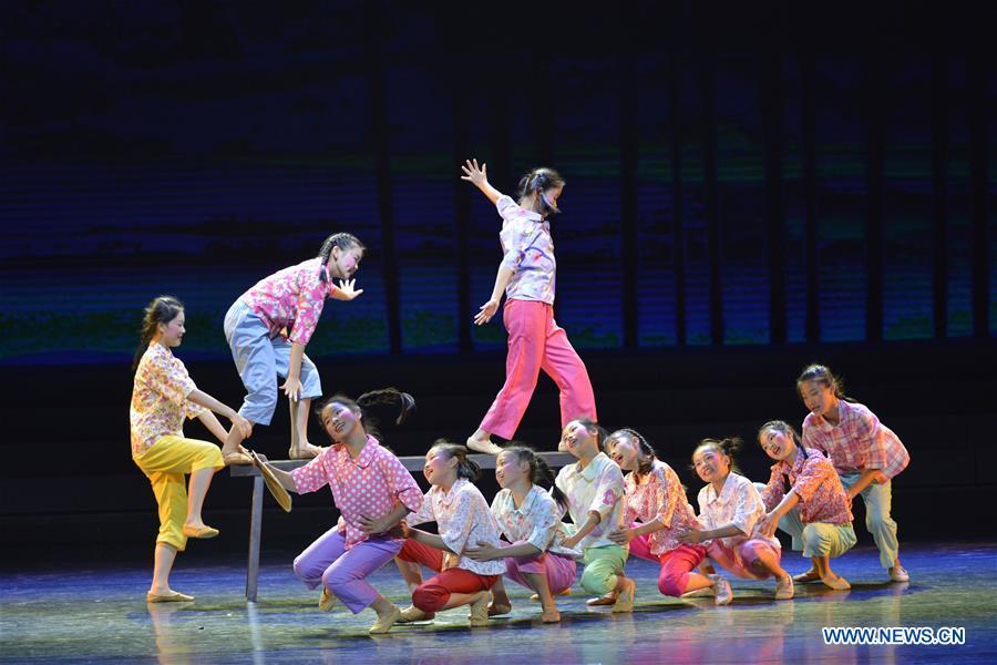 Students dance at No. 2 Experimental Primary School in Lianjiang County, southeast China\'s Fujian Province, Oct. 28, 2018. China\'s primary and middle schools have been urged to improve education for all-around student development, according to a directive issued by authorities. Jointly issued by the Ministry of Education and other eight agencies, the circular asked schools to offer courses that are in accord with the national syllabus in terms of their quantity and quality. The enhancement of courses\' difficulty levels and speed at random and in disregard of the curriculum is prohibited, according to the circular. Primary and junior middle schools are not allowed to set up any \