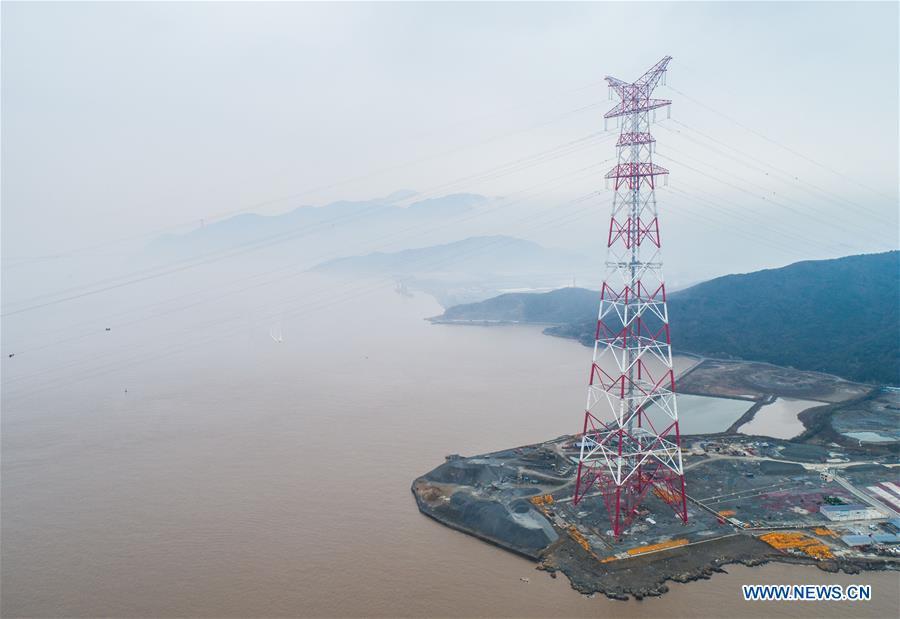 Aerial photo taken on Jan. 3, 2019 shows one of the giant power supply pylons in Zhoushan, east China\'s Zhejiang Province. The two 380-meter-tall pylons carry power cables between Zhoushan\'s Jintang and Cezi islands, a distance of 2,656 meters. The new pylon project is a part of a new ultra-high voltage power line project between cities of Zhoushan and Ningbo. (Xinhua/Xu Yu)