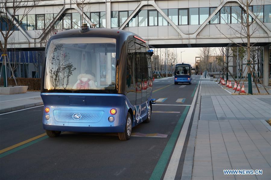 Self-driving cars run at the Xiongan public services center in Xiongan New Area, north China\'s Hebei Province, Dec. 7, 2018. China\'s central authorities have approved the 2018-2035 master plan for Xiongan New Area, stressing that its creation is significant to high-quality development and the building of the modern economic system. The plan was approved by the Central Committee of the Communist Party of China (CPC) and the State Council. The master plan is the fundamental guideline for the development, construction and management of the Xiongan New Area and should be strictly implemented, according to the approval released on Wednesday. The plan also lists overall development goals for the new area. By 2035, Xiongan will basically develop into a modern city that is green, intelligent and livable, with relatively strong competitiveness and harmonious human-environment interaction. (Xinhua/Mu Yu)