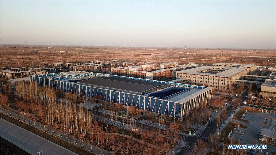 Aerial photo taken on Dec. 7, 2018 shows the Xiongan public services center in Xiongan New Area, north China\'s Hebei Province. China\'s central authorities have approved the 2018-2035 master plan for Xiongan New Area, stressing that its creation is significant to high-quality development and the building of the modern economic system. The plan was approved by the Central Committee of the Communist Party of China (CPC) and the State Council. The master plan is the fundamental guideline for the development, construction and management of the Xiongan New Area and should be strictly implemented, according to the approval released on Wednesday. The plan also lists overall development goals for the new area. By 2035, Xiongan will basically develop into a modern city that is green, intelligent and livable, with relatively strong competitiveness and harmonious human-environment interaction. (Xinhua/Yang Shiyao)