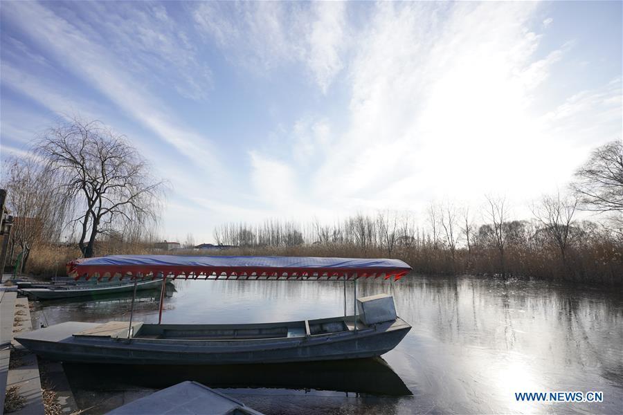 A boat is moored on the Baiyangdian lake in Xiongan New Area, north China\'s Hebei Province, Dec. 7, 2018. China\'s central authorities have approved the 2018-2035 master plan for Xiongan New Area, stressing that its creation is significant to high-quality development and the building of the modern economic system. The plan was approved by the Central Committee of the Communist Party of China (CPC) and the State Council. The master plan is the fundamental guideline for the development, construction and management of the Xiongan New Area and should be strictly implemented, according to the approval released on Wednesday. The plan also lists overall development goals for the new area. By 2035, Xiongan will basically develop into a modern city that is green, intelligent and livable, with relatively strong competitiveness and harmonious human-environment interaction. (Xinhua/Xing Guangli)