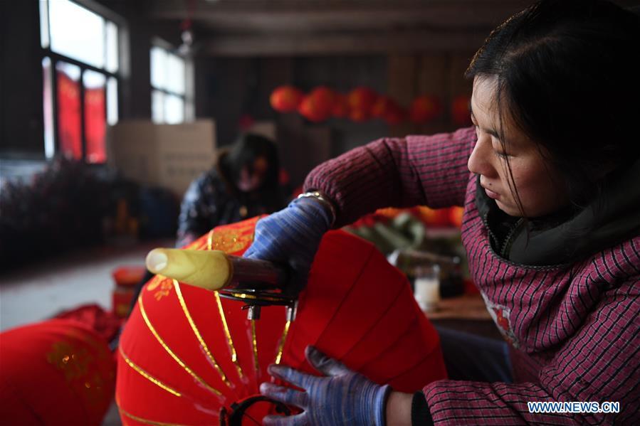 A villager works in a lantern workshop for the upcoming peak sales season of Spring Festival in Jifeng Town of Jishan County in Yuncheng, north China\'s Shanxi Province, Jan. 3, 2019. (Xinhua/Yang Chenguang)