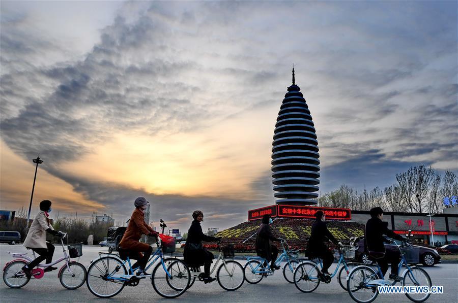 Citizens ride in Rongcheng County of Xiongan New Area, north China\'s Hebei Province, March 29, 2018. China\'s central authorities have approved the 2018-2035 master plan for Xiongan New Area, stressing that its creation is significant to high-quality development and the building of the modern economic system. The plan was approved by the Central Committee of the Communist Party of China (CPC) and the State Council. The master plan is the fundamental guideline for the development, construction and management of the Xiongan New Area and should be strictly implemented, according to the approval released on Wednesday. The plan also lists overall development goals for the new area. By 2035, Xiongan will basically develop into a modern city that is green, intelligent and livable, with relatively strong competitiveness and harmonious human-environment interaction. (Xinhua/Mu Yu)