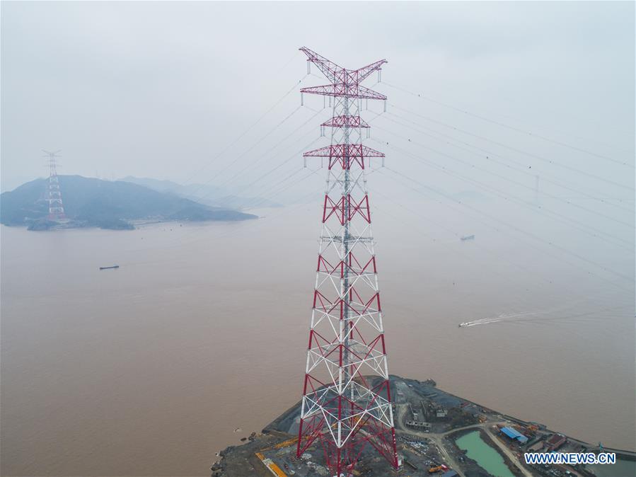 Aerial photo taken on Jan. 3, 2019 shows the giant power supply pylons in Zhoushan, east China\'s Zhejiang Province. The two 380-meter-tall pylons carry power cables between Zhoushan\'s Jintang and Cezi islands, a distance of 2,656 meters. The new pylon project is a part of a new ultra-high voltage power line project between cities of Zhoushan and Ningbo. (Xinhua/Xu Yu)