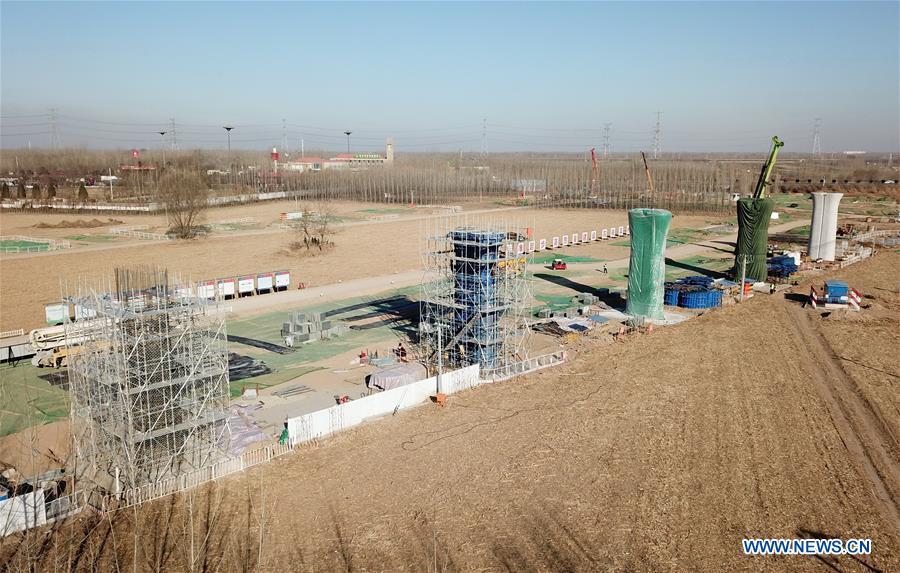 Aerial photo taken on Dec. 8, 2018 shows the construction site of the inter-city railway between Beijing, capital of China, and Xiong\'an New Area of north China\'s Hebei Province. China\'s central authorities have approved the 2018-2035 master plan for Xiongan New Area, stressing that its creation is significant to high-quality development and the building of the modern economic system. The plan was approved by the Central Committee of the Communist Party of China (CPC) and the State Council. The master plan is the fundamental guideline for the development, construction and management of the Xiongan New Area and should be strictly implemented, according to the approval released on Wednesday. The plan also lists overall development goals for the new area. By 2035, Xiongan will basically develop into a modern city that is green, intelligent and livable, with relatively strong competitiveness and harmonious human-environment interaction. (Xinhua/Yang Shiyao)