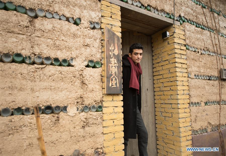 Mehraz Karami walks out of his workshop at Shanbei Village in Daixi Town of Huzhou City, east China\'s Zhejiang Province, Jan. 7, 2019. Iranian Mehraz Karami, who was born in Tehran in 1993, has shown his interest in Chinese culture ever since his childhood. He came to Daixi Town and set up his own painting workshop at the end of 2017 after graduation from east China\'s Shanghai. He said he hoped to stay in China and become an artist. (Xinhua/Weng Xinyang)