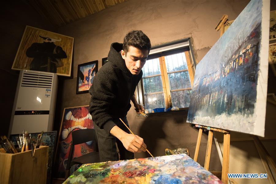 Mehraz Karami paints at his workshop in Shanbei Village of Daixi Town in Huzhou City, east China\'s Zhejiang Province, Jan. 7, 2019. Iranian Mehraz Karami, who was born in Tehran in 1993, has shown his interest in Chinese culture ever since his childhood. He came to Daixi Town and set up his own painting workshop at the end of 2017 after graduation from east China\'s Shanghai. He said he hoped to stay in China and become an artist. (Xinhua/Weng Xinyang)