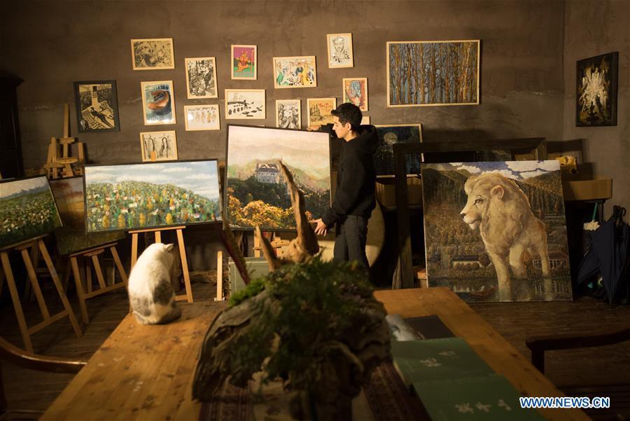 Mehraz Karami arranges paintings at his workshop in Shanbei Village of Daixi Town in Huzhou City, east China\'s Zhejiang Province, Jan. 7, 2019. Iranian Mehraz Karami, who was born in Tehran in 1993, has shown his interest in Chinese culture ever since his childhood. He came to Daixi Town and set up his own painting workshop at the end of 2017 after graduation from east China\'s Shanghai. He said he hoped to stay in China and become an artist. (Xinhua/Weng Xinyang)