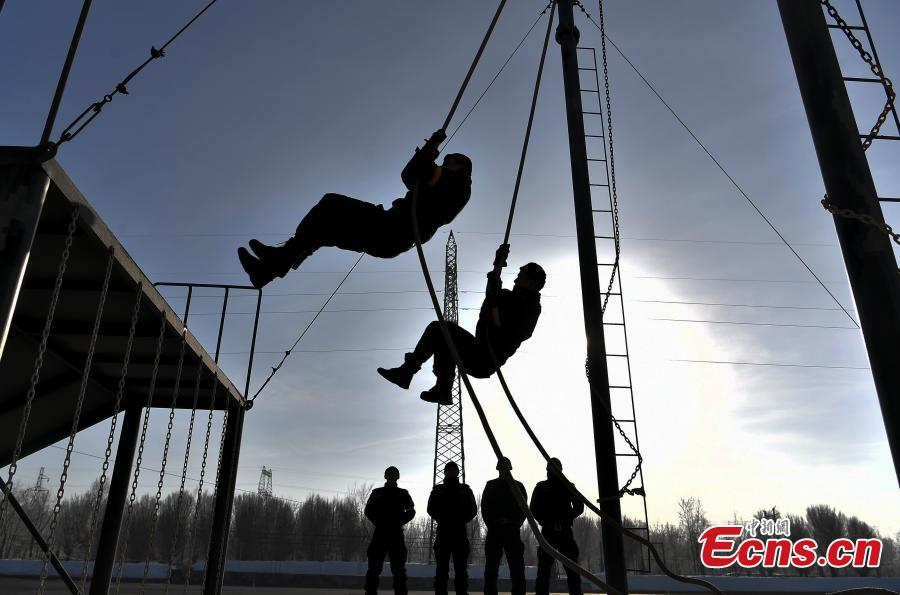 Members of the special police force of Urumqi City, Northwest China\'s Xinjiang Uygur Autonomous Region, undergo an intensive training at a snow field in freezing conditions, Jan. 9, 2019. The 60-plus day winter training included running, the use of police equipment and combat skills. (Photo: China News Service/Liu Xin)
