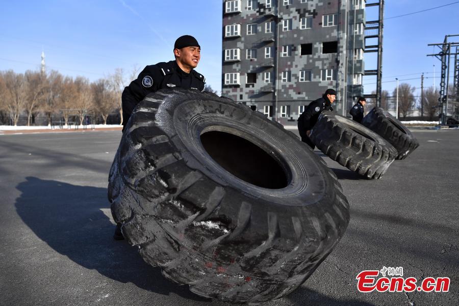 Members of the special police force of Urumqi City, Northwest China\'s Xinjiang Uygur Autonomous Region, undergo an intensive training at a snow field in freezing conditions, Jan. 9, 2019. The 60-plus day winter training included running, the use of police equipment and combat skills. (Photo: China News Service/Liu Xin)