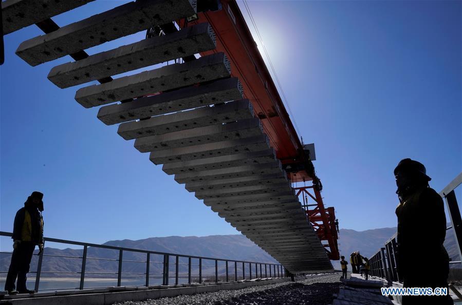 Staff members work at the construction site of the Lhasa-Nyingchi section of the Sichuan-Tibet Railway in southwest China\'s Tibet Autonomous Region, on Nov. 26, 2018. In 2018, an investment of 4.2 billion yuan (623 million U.S. dollars) was made in railway construction in the region. (Xinhua/Purbu Zhaxi)