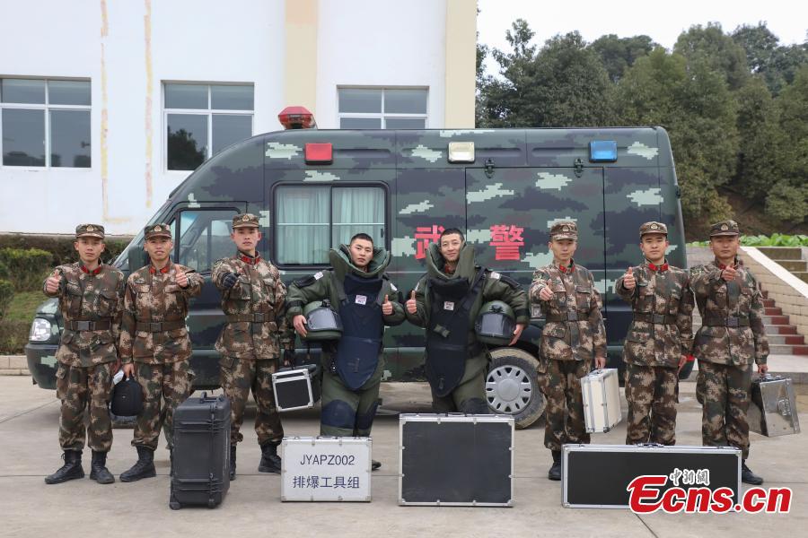 Members of the armed police bomb squad pose for a photo after a training exercise in Guizhou Province, Jan. 14, 2019. Wearing anti-explosion coveralls weighing 30 kilograms each, members of the armed police unit specializing in explosive ordnance disposal conducted a drill on Monday, aided by a remotely-controlled bomb disposal device. (Photo: China News Service/Qu Honglun)