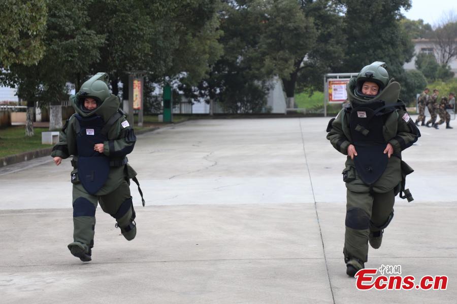 Li Degui (R) and Deng Yutang, both wearing anti-explosion coveralls, compete during a training in Guizhou Province, Jan. 14, 2019. Wearing anti-explosion coveralls weighing 30 kilograms each, members of the armed police unit specializing in explosive ordnance disposal conducted a drill on Monday, aided by a remotely-controlled bomb disposal device. (Photo: China News Service/Qu Honglun)