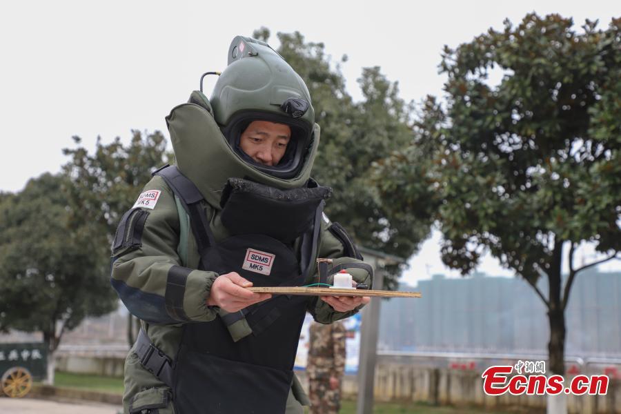 Li Degui, a member of the armed police bomb squad, balances himself during a training exercise in Guizhou Province, Jan. 14, 2019. Wearing anti-explosion coveralls weighing 30 kilograms each, members of the armed police unit specializing in explosive ordnance disposal conducted a drill on Monday, aided by a remotely-controlled bomb disposal device. (Photo: China News Service/Qu Honglun)