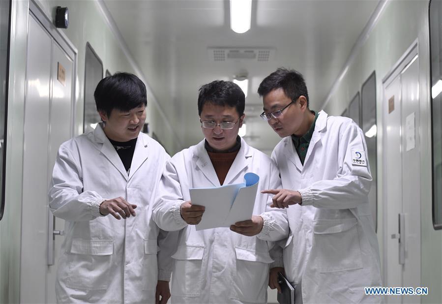 Staff members of Institute of Optics and Electronics of the Chinese Academy of Sciences discuss the plan of testing the topographical camera installed on the lander of the Chang\'e-4 probe in Chengdu, southwest China\'s Sichuan Province, Jan. 17, 2019. The topographical camera installed on the lander of the Chang\'e-4 probe is responsible for both taking colorful high-resolution images on the lunar surface and monitoring the lunar rover Yutu-2. China\'s Chang\'e-4 lunar probe, comprising a lander and a rover, landed on the far side of the moon on Jan. 3, 2019. (Xinhua/Liu Kun)