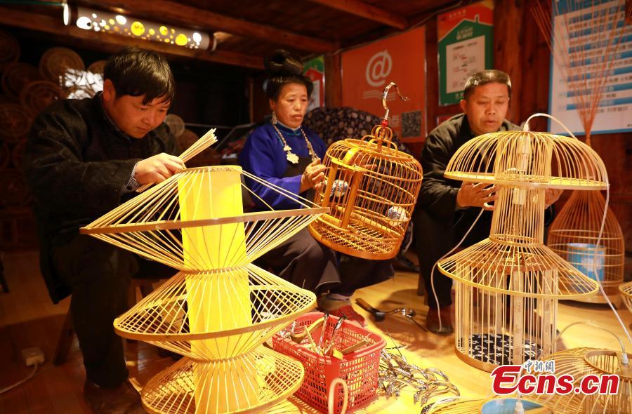 Villagers make bird cage-shaped lanterns, to be used in Chinese New Year celebrations, in Kala Village, Danzhai County, Southwest China\'s Guizhou Province, Jan. 17, 2019. Wang Yuhe is a master of the craft, recognized as an intangible cultural heritage by the province in 2008. The village is famous for producing bird cage-shaped lanterns. (Photo: China News Service/Huang Xiaohai)