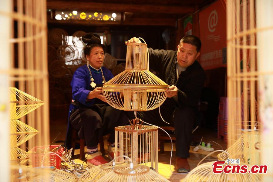 Craftsman Wang Yuhe makes a bird cage-shaped lantern, to be used in Chinese New Year celebrations, in Kala Village, Danzhai County, Southwest China\'s Guizhou Province, Jan. 17, 2019. Wang is a master of the craft, recognized as an intangible cultural heritage by the province in 2008. The village is famous for producing bird cage-shaped lanterns. (Photo: China News Service/Huang Xiaohai)