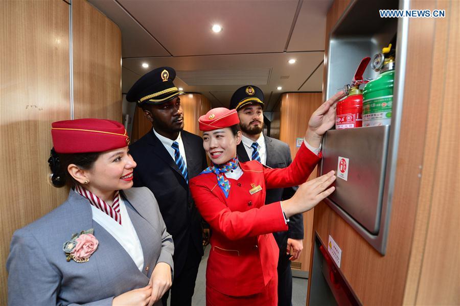 Foreign volunteers receive professional training at Xi\'an North Railway Station in Xi\'an, capital of northwest China\'s Shaanxi Province, Jan. 20, 2019. Three foreign student volunteers from Xi\'an Jiaotong University came to Xi\'an North Railway Station on Sunday to familiarize themselves with the train staff members\' work. They would serve passengers during the Spring Festival travel rush. The Spring Festival, or the Year of the Pig in the Chinese lunar calendar, will begin on Feb. 5 this year. The 40-day 2019 Spring Festival travel rush started on Jan. 21, with 3 billion trips expected to be made. (Xinhua/Tang Zhenjiang)