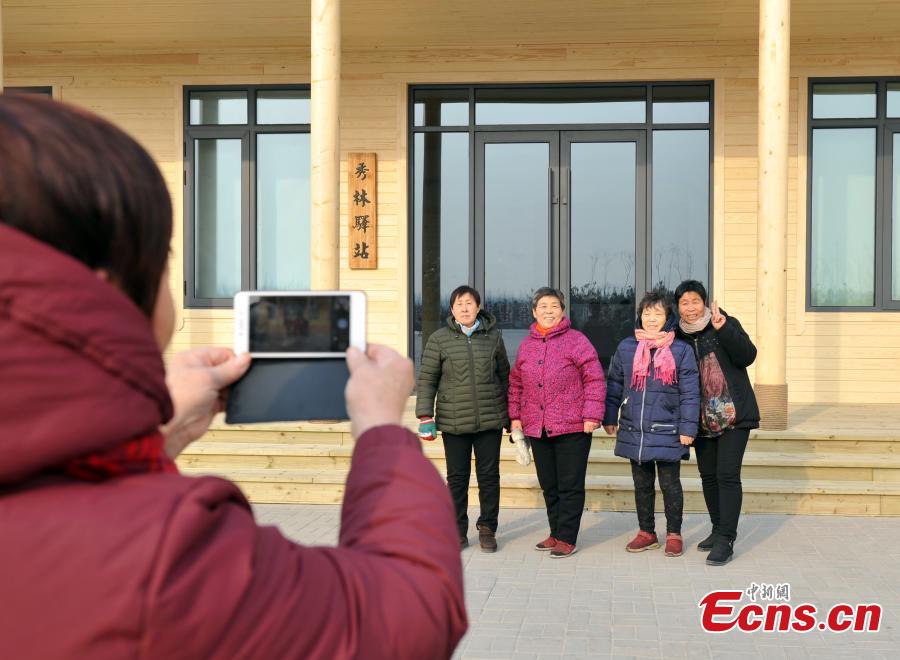 Local villagers pose near a forest that is being developed in Xiongan New Area in North China\'s Hebei Province. Progress has been made two years after China announced the establishment of Xiongan New Area in April 2017, spanning three counties in Hebei Province about 100 km southwest of Beijing. (Photo: China News Service/Han Bing)