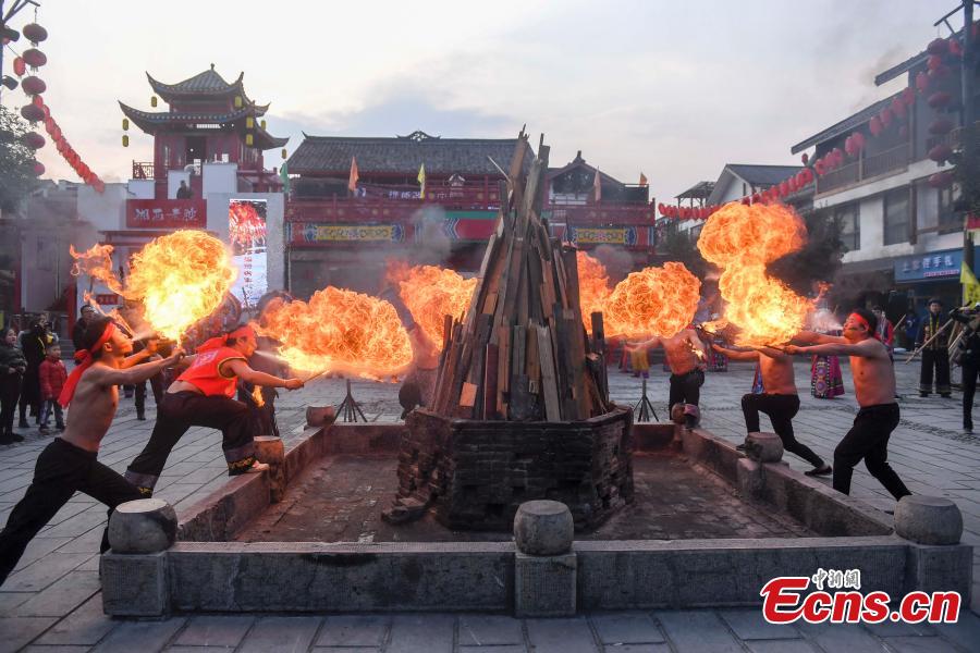 Performers present a fire stunt show at the Wulingyuan scenic area in Zhangjiajie City, Central China\'s Hunan Province, Jan. 21, 2019. Zhangjiajie, a UNESCO World Heritage Site, is known for its forest parks and Wulingyuan is famous for its more than 3,000 sandstone pillars. (Photo: China News Service/Yang Huafeng)