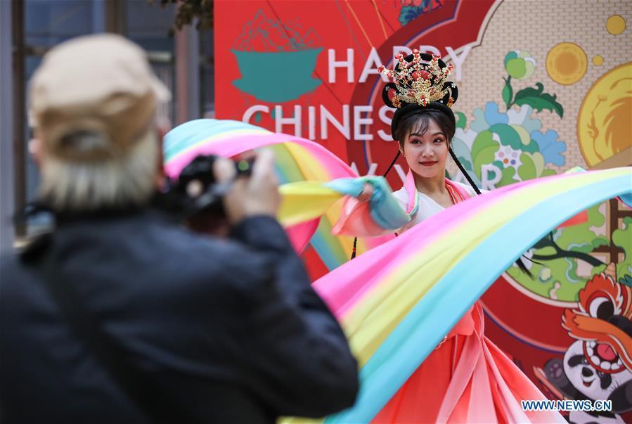 A visitor takes photos of a dancer in a shopping mall at Potsdamer Platz in Berlin, capital of Germany, on Jan. 24, 2019. \