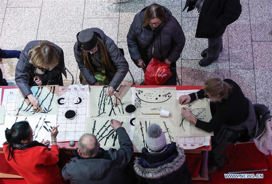 Visitors learn traditional Chinese painting in a shopping mall at Potsdamer Platz in Berlin, capital of Germany, on Jan. 24, 2019. \