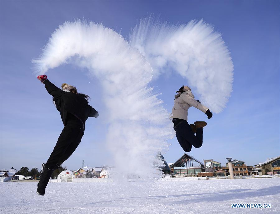 Visitors play a game with water spray in Beiji Village, Mohe City of northeast China\'s Heilongjiang Province, Jan. 24, 2019. With the lowest temperature approaching minus 30 degrees celsius, visitors in Mohe Village experienced the game of \