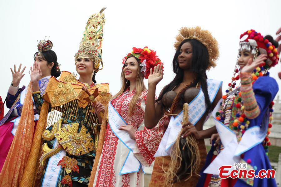 Contestants of the 53rd Miss All Nations Pageant brave the winter chill to pose for a photo in Nanjing, east China\'s Jiangsu Province, Jan. 28, 2019. The pageant will be held on Jan. 29 to promote Eco-Tourism. (Photo: China News Service/Yang Bo)