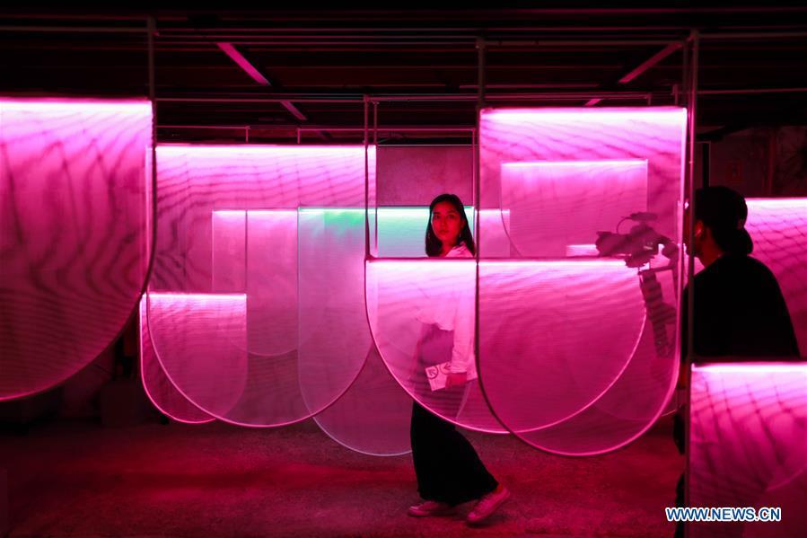 Visitors shoot amid a light installation during the Bangkok Design Week 2019 in Bangkok, Thailand, Jan. 30, 2019. The Bangkok Design Week 2019 was held under the theme \