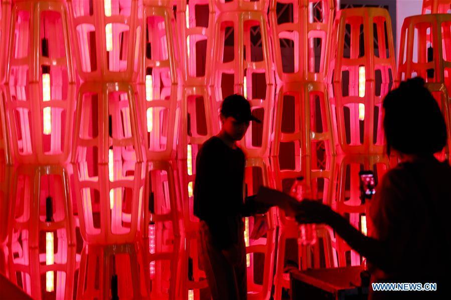 A visitor poses for a photo amid a light installation during the Bangkok Design Week 2019 in Bangkok, Thailand, Jan. 30, 2019. The Bangkok Design Week 2019 was held under the theme \