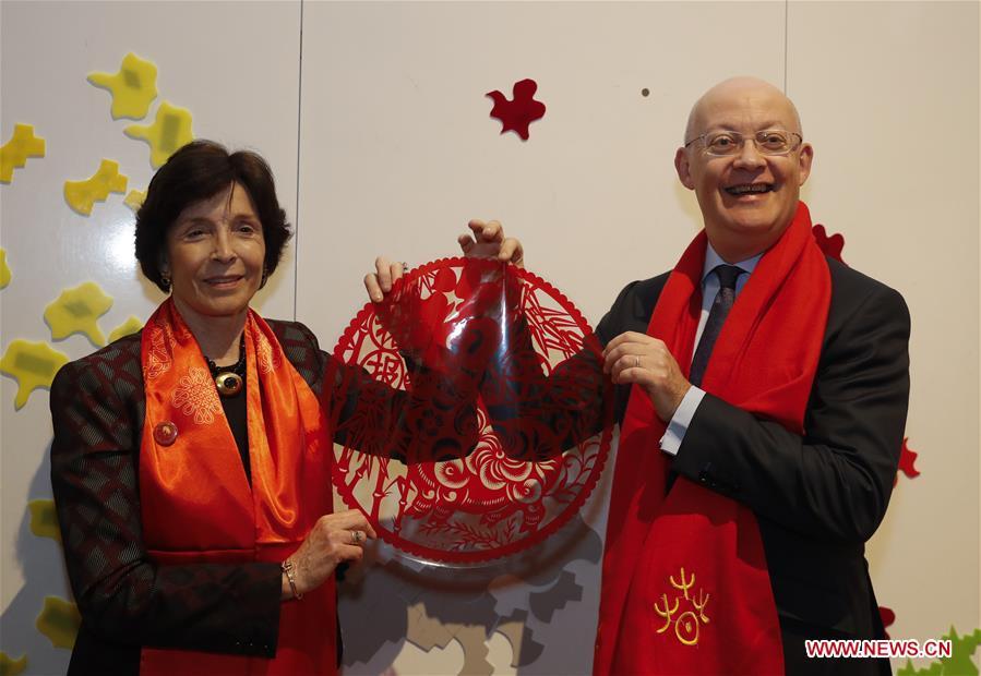 Ian Blatchford (R), director of the Science Museum Group, expresses his good wishes with a Chinese traditional paper-cutting image in his hands ahead of celebrations of the Chinese Lunar New Year at the Science Museum in London, Britain on Jan. 30, 2019. With Chinese folk music, Kongfu performance, and lion and dragon dances, the Science Museum in London was brimming with pleasure Wednesday night. Around 5,000 visitors joined the China Lates programs in the museum to celebrate the Chinese Lunar New Year, which falls on Feb. 5. (Xinhua/Han Yan)