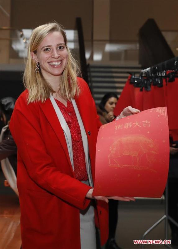 A visitor reacts during celebrations of the Chinese Lunar New Year at the Science Museum in London, Britain on Jan. 30, 2019. With Chinese folk music, Kongfu performance, and lion and dragon dances, the Science Museum in London was brimming with pleasure Wednesday night. Around 5,000 visitors joined the China Lates programs in the museum to celebrate the Chinese Lunar New Year, which falls on Feb. 5. (Xinhua/Han Yan)