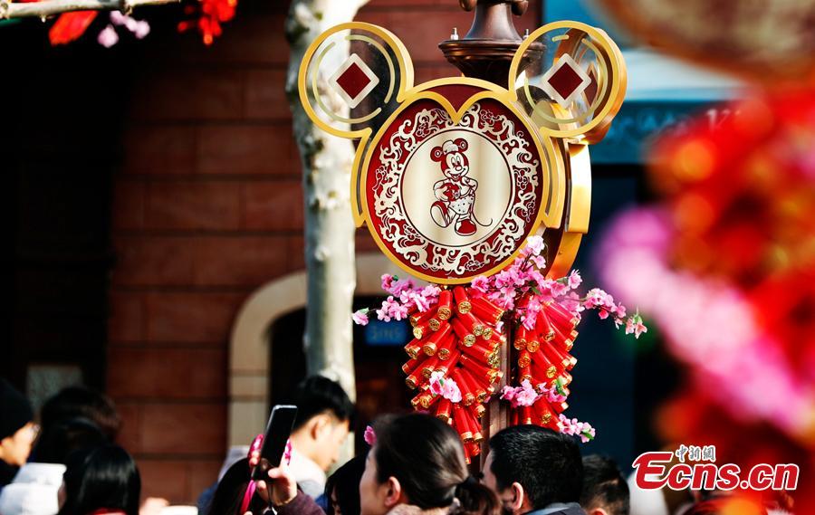 Visitors are seen in the Shanghai Disney Resort to greet \