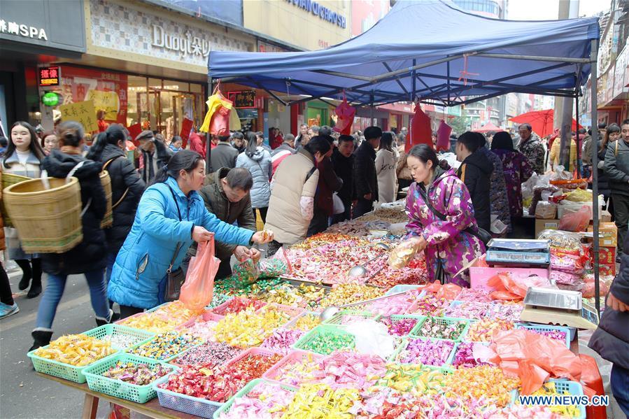 Customers buy candies at a local market in Yuping Dong Autonomous County of Tongren City, southwest China\'s Guizhou Province, Jan. 31, 2019. People are busy buying goods in Guizhou for the upcoming Spring Festival, which falls on Feb. 5 this year. (Xinhua/Liu Dejun)