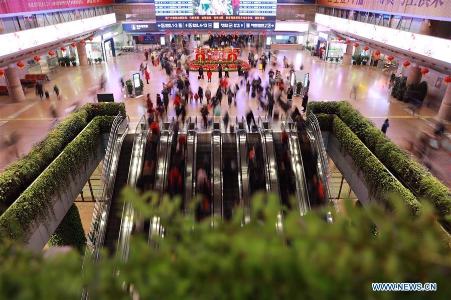 Passengers walk to board trains at the Beijing West Railway Station in Beijing, capital of China, Feb. 1, 2019. China Railway Beijing Group Co., Ltd. was estimated to send 1.03 million passengers on Friday. Beijing railway was witnessing mounting travel rush as people began to embark on trips for this year\'s lunar New Year, which falls on Feb. 5. (Xinhua/Xing Guangli)