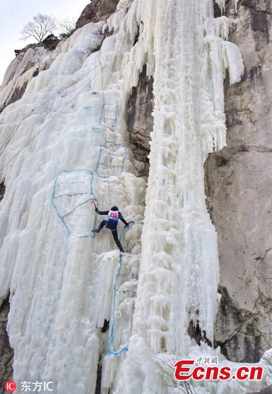 A participant ascends a frozen fall during a competition in Vladivostok, Russia, Feb. 9, 2019. (Photo/IC)